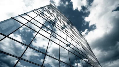 Glass high-rise reflecting clouds.