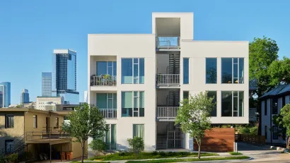 Rendering of white three-story single-stair building in Austin, Texas with staircase in the middle.
