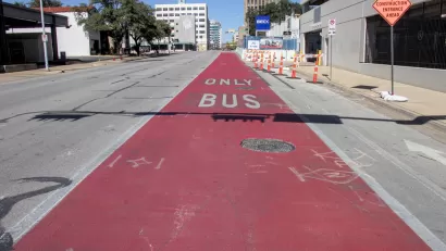 A bright red traffic lane reads “Bus Only.”