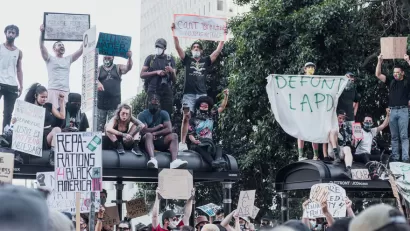 A group of protestors support Black Lives Matter and call for police reforms while gathered on top of a bus stop in Los Angeles.