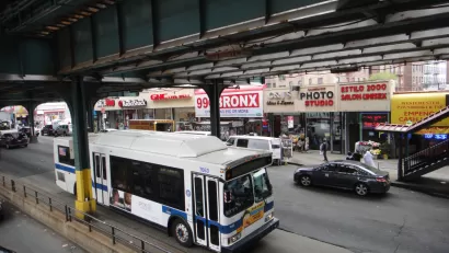 A New York MTA drives down the straight under elevated train tracks in the Bronx in New York City