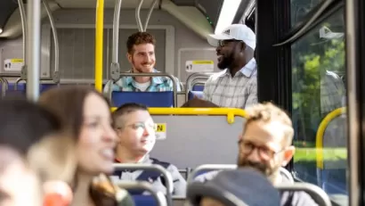 Group of cheery riders inside a CDTA public transit bus.