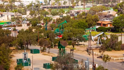View of neighborhood with oil wells between houses