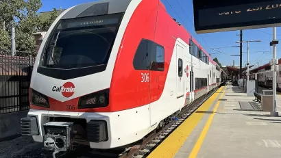 Red and white Caltrain electric train at platform in San Jose, California.