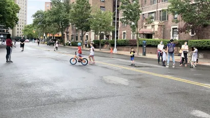 Children and adults biking and hanging out on an Open Street closed to vehicles in New York City during the Covid-19 pandemic.