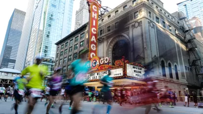 Runner passing the Chicago Theater are blurred as they pass by the camera for a race on the streets of Downtown Chicago.