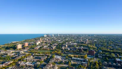An aerial view of the South Side of Chicago, with Lake Michigan to the left in the distance. 