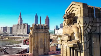 One of the "Guardians of Traffic" in Cleveland, a scuplture of a large figure adorning a bridge in Cleveland. Downtown Cleveland is in the background.