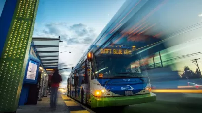 Low view looking up at bus rapid transit bus at station in Snohomish County, Washington with blur to indicate motion.