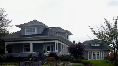 Craftsman-style two-story home with detached converted garage apartment accessory dwelling unit.