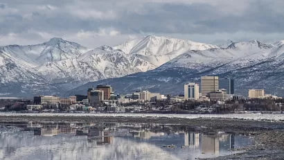 Downtown Anchorage with the snow covered Chugach Mountains in the background.