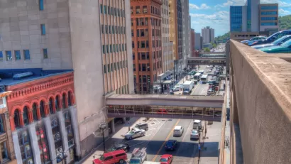 A busy street in Duluth, full of cars and buses.