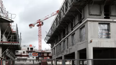 Cranes rise into the sky on a construction site for an office and housing building for the Bouygues Group in the southern suburbs of Paris.