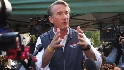 Glenn Youngkin gesturing with his hands while speaking to the media and the public while campaigning for governor of Virginia at the Alexandria Farmers Market.