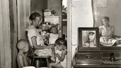 Mrs. Ella Watson, a government charwoman, with three grandchildren and her adopted daughter