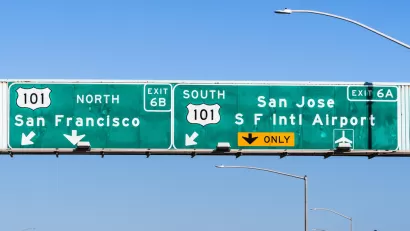 A highway sign reads with directions to reach San Francisco to the north and San Jose to the south--both on Highway 101.