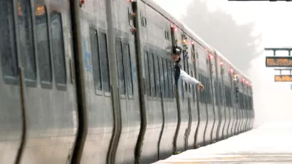 A train conductor waves at an empty platform on the Long island Rail Road system.