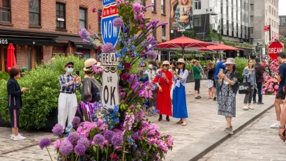 People gather on a street with no cars during the L.E.A.F. Festival of Flowers in the Meatpacking District of New York City.