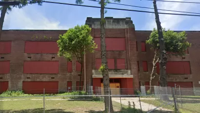 Google street view of vacant, boarded-up brick high school building in Memphis, Tennessee.