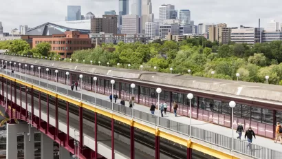The Washington St Bridge in Minneapolis is shown with downtown Minneapolis in the background.