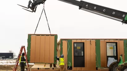 Modular housing being installed with crane.