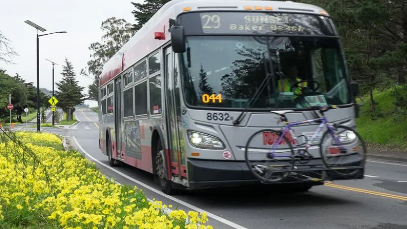 Silver #29 San Francisco Muni bus with bike on front rack.