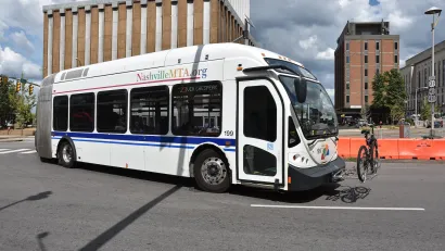 White public transit bus with bike on front bike rack in Nashville, Tennessee.