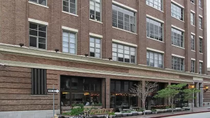 View of the National Biscuit Company Building, 1850 Industrial Street, Los Angeles from the corner of Mateo Street. It has been renovated into lofts, with a restaurant on the ground floor.