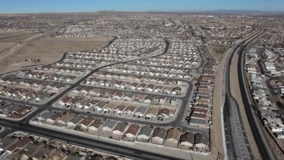 A spraling subdivision of single-family detached housing in a desert setting.