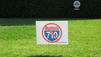 "No 710" lawn sign on green lawn.