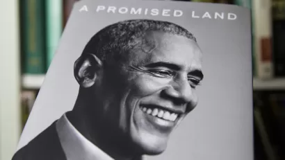 An image of the book "A Promised Land," by Barack Obama shows a black and white photo of the former president smiling.