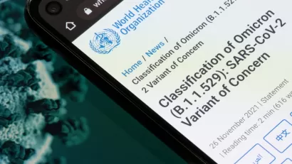 An image showing a smart phone with information from the World Health Organization about the Omicron variant of the coronavirus.