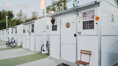 Row of Pallet Shelter tiny home units with bicycles in front