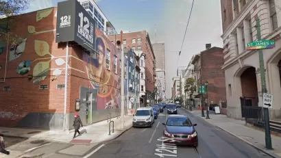 An image of a mural depicting Gloria Casarez on the outside of a gym on 12street in Philadelphia.