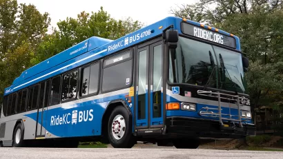 Blue RideKC bus in Kansas City with trees in background