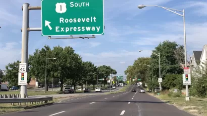 View of three-lane Roosevelt Boulevard with green Roosevelt Expressway road sign in Philadelphia, Pennsylvania.