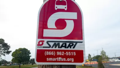 A sign for SMART Bus on a pole.