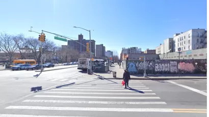 Google street view of New York City intersection with construction fence