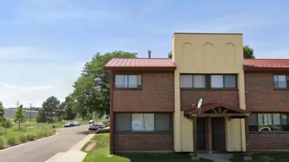 Google street view of two-story brick and stucco apartment building in Sun Valley neighborhood of Denver, Colorado.