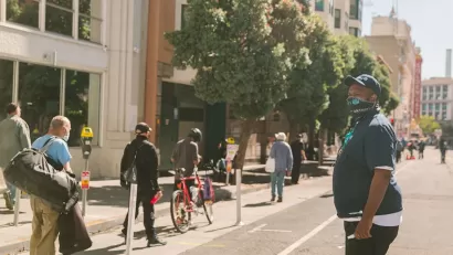 People walking and biking on protected bike lane in Tenderloin District, San Francisco.