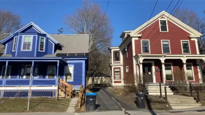 Blue and red colonial-style multifamily homes in Vermont.