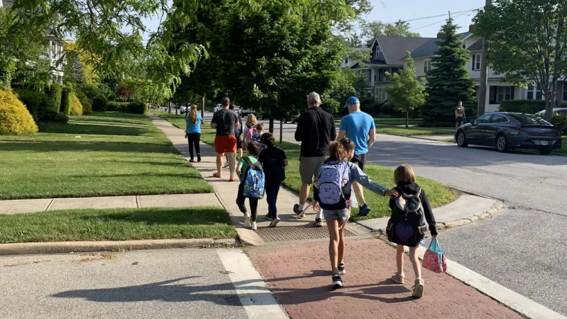 Children crossing a crosswalk paved with red bricks in Lakewood, Ohio.