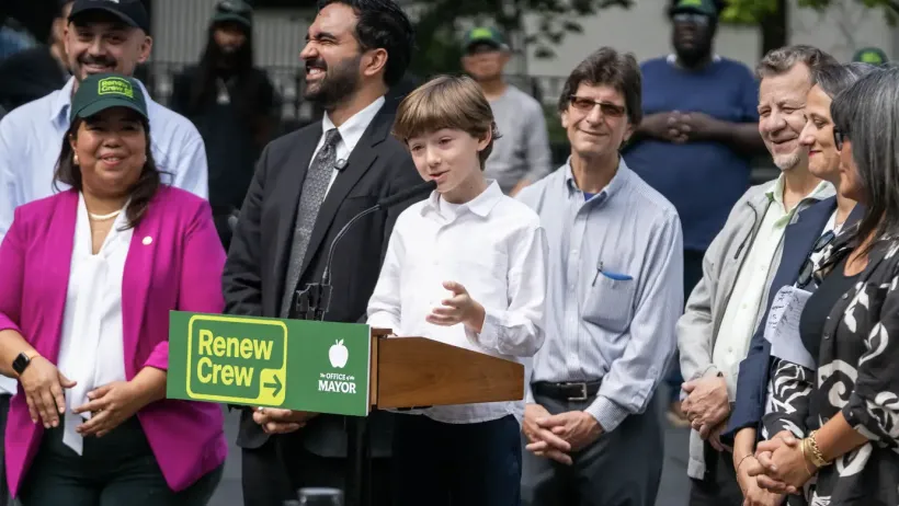 Eight-year old Max Kakhidze speaks at a press conference with Zohran Mandami in the background.