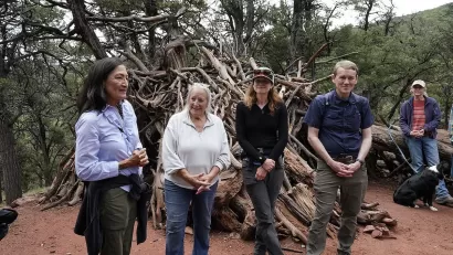 Interior Secretary Deb Haaland standing in a forested area in Colorado to celebrate recent action by the Biden-Harris administration to withdraw around 220,000 acres in the Thompson Divide area for mineral leasing on 1 July 2024.