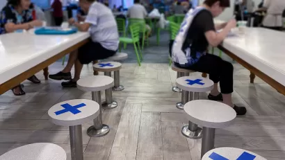 A restaurant in Singapore places tape on seats to maintain distance between diners during the Covid-19 pandemic in 2020.