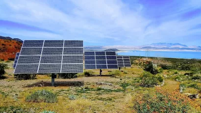 Solar panels installed ona hillside with Lake Mead, Nevada in background.