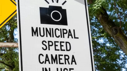 "Municipal speed camera in use" sign