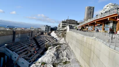 Construction on a tunnel is visible next to the Seattle waterfront.