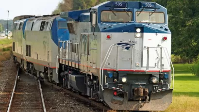 Amtrak Sunset Limited train passing by forested area in Cade, Louisiana
