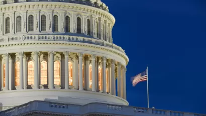 A close up image of the exterior of the U.S. Capitol Rotunda illuminated at dusk.